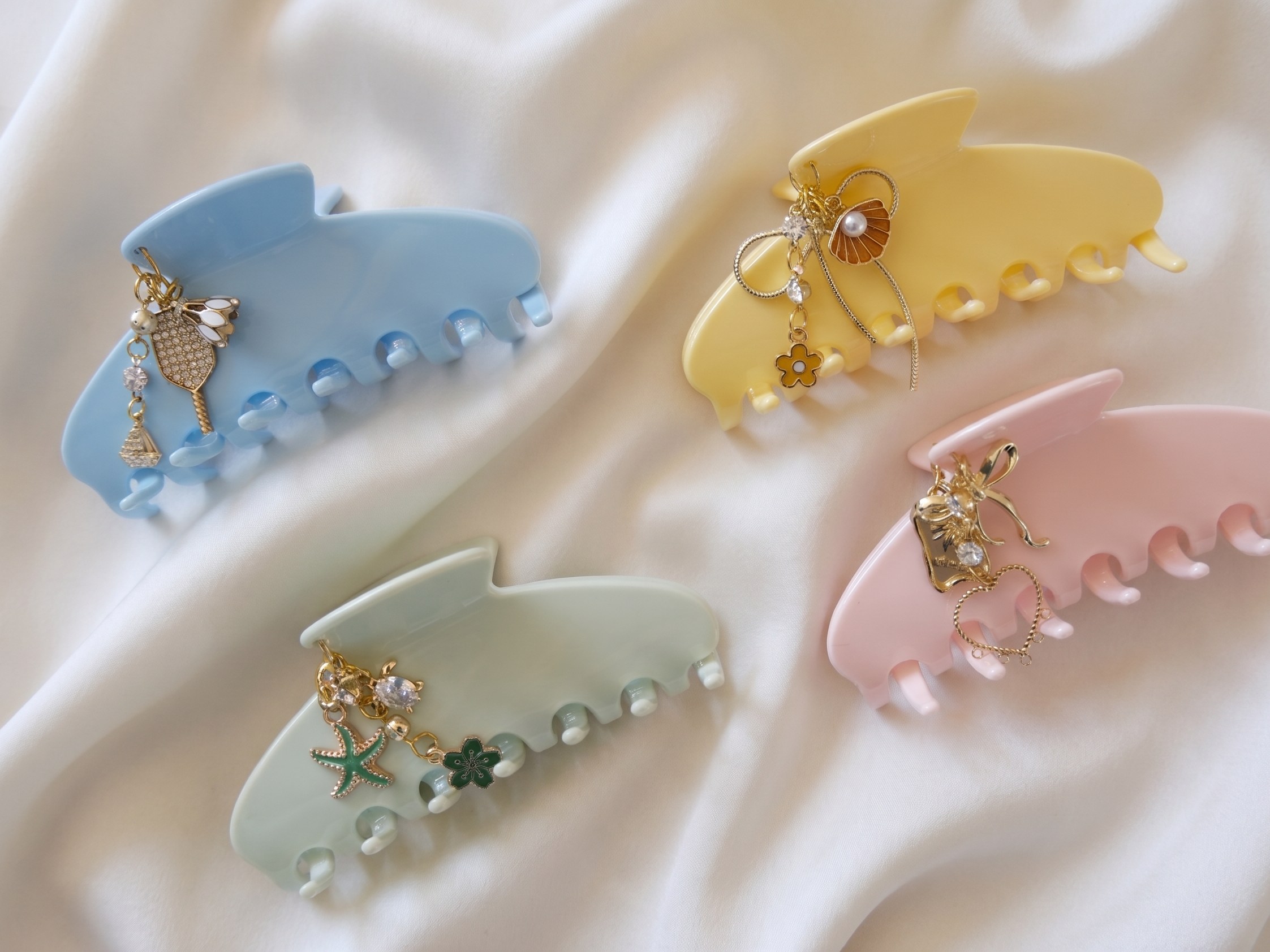 All four Lehr claw clips on cream silk